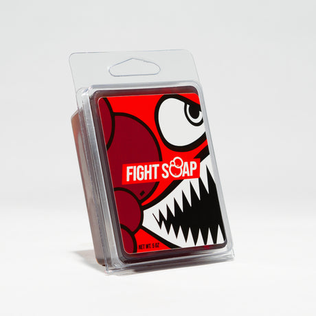 A package of "Fight Soap" with a cartoonish, aggressive monster face featuring sharp teeth and large eyes, on a red background.