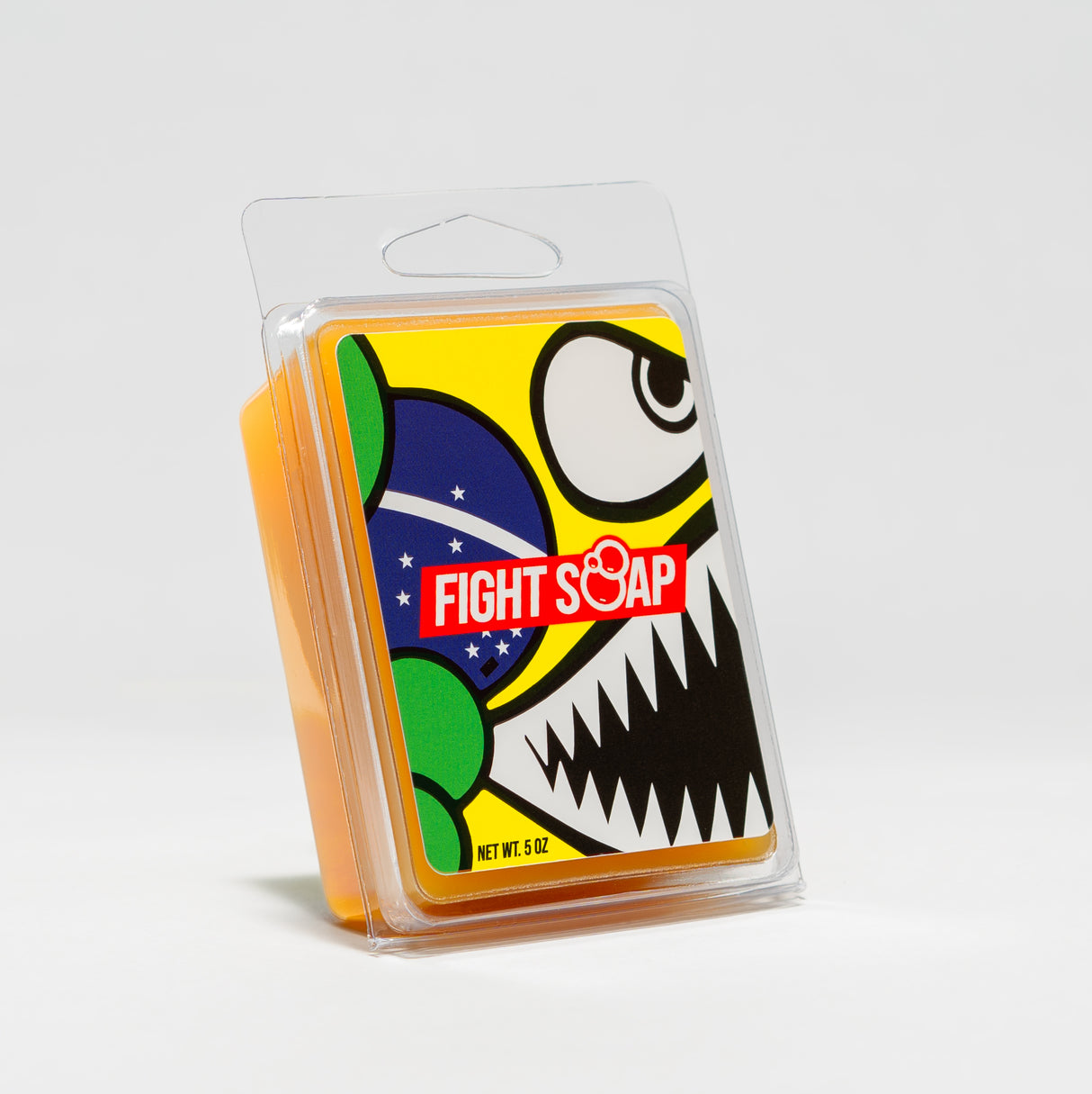 Colorful soap packaging featuring a cartoon skull with bold black teeth, large eye, and a Brazilian flag design.