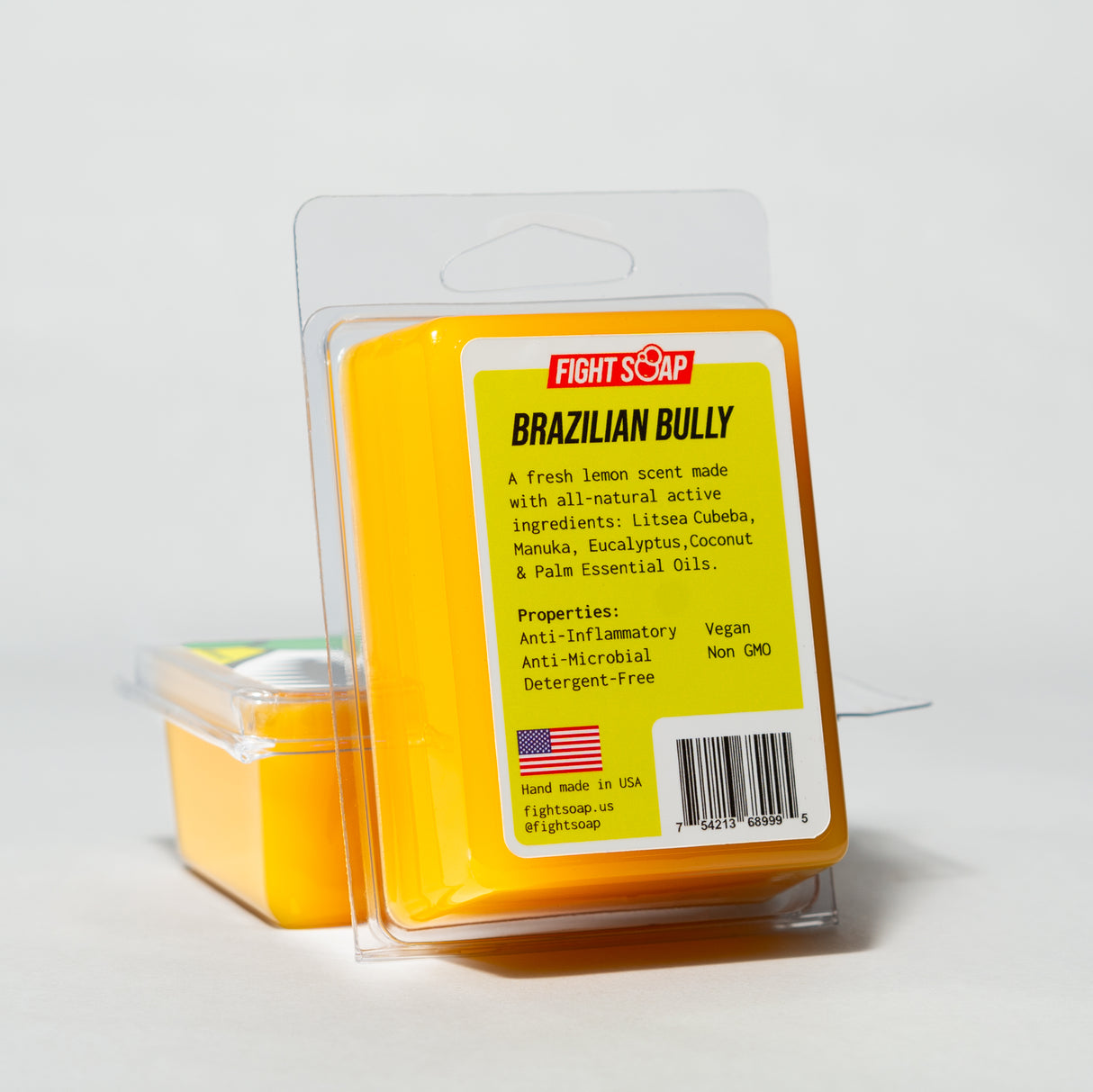 A yellow bar of Fight Soap labeled "Brazilian Bully" with natural ingredients and properties like anti-inflammatory and vegan.