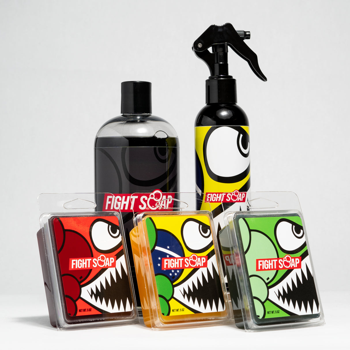 A collection of Fight Soap products featuring colorful packaging with cartoon monster designs, including spray bottles and soap bars.