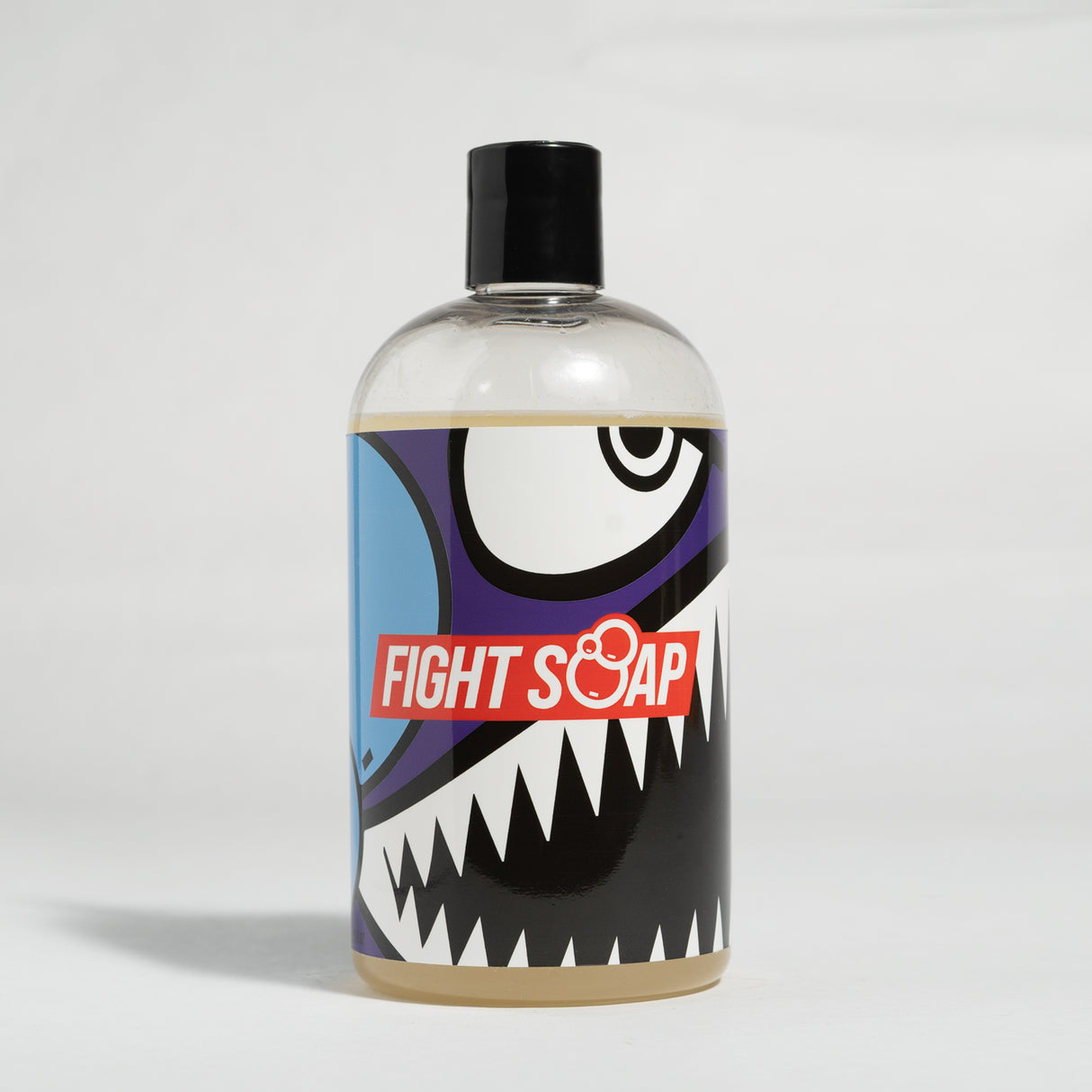 A clear plastic bottle of Vice Body Wash with a black cap, featuring bold, cartoon-style shark graphic and "Fight Soap" label.