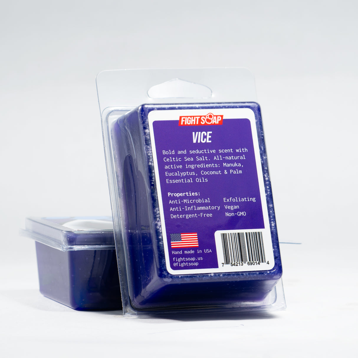 A bar of violet-colored soap labeled "VICE" in clear packaging, with details about ingredients and properties on the front.