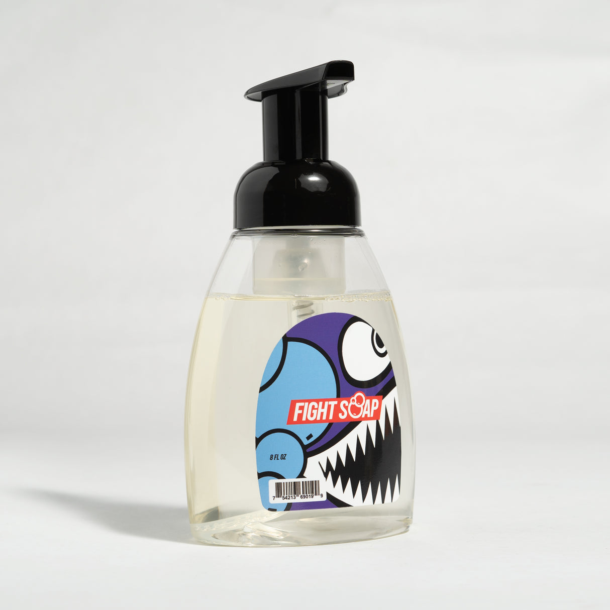 A clear foaming hand soap with a black pump dispenser and a colorful cartoon monster label reading "Fight Soap.