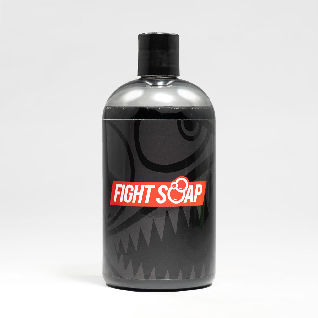 A black bottle of Fight Soap with a bold red and white label, featuring a shark design and a black cap, on a white background.
