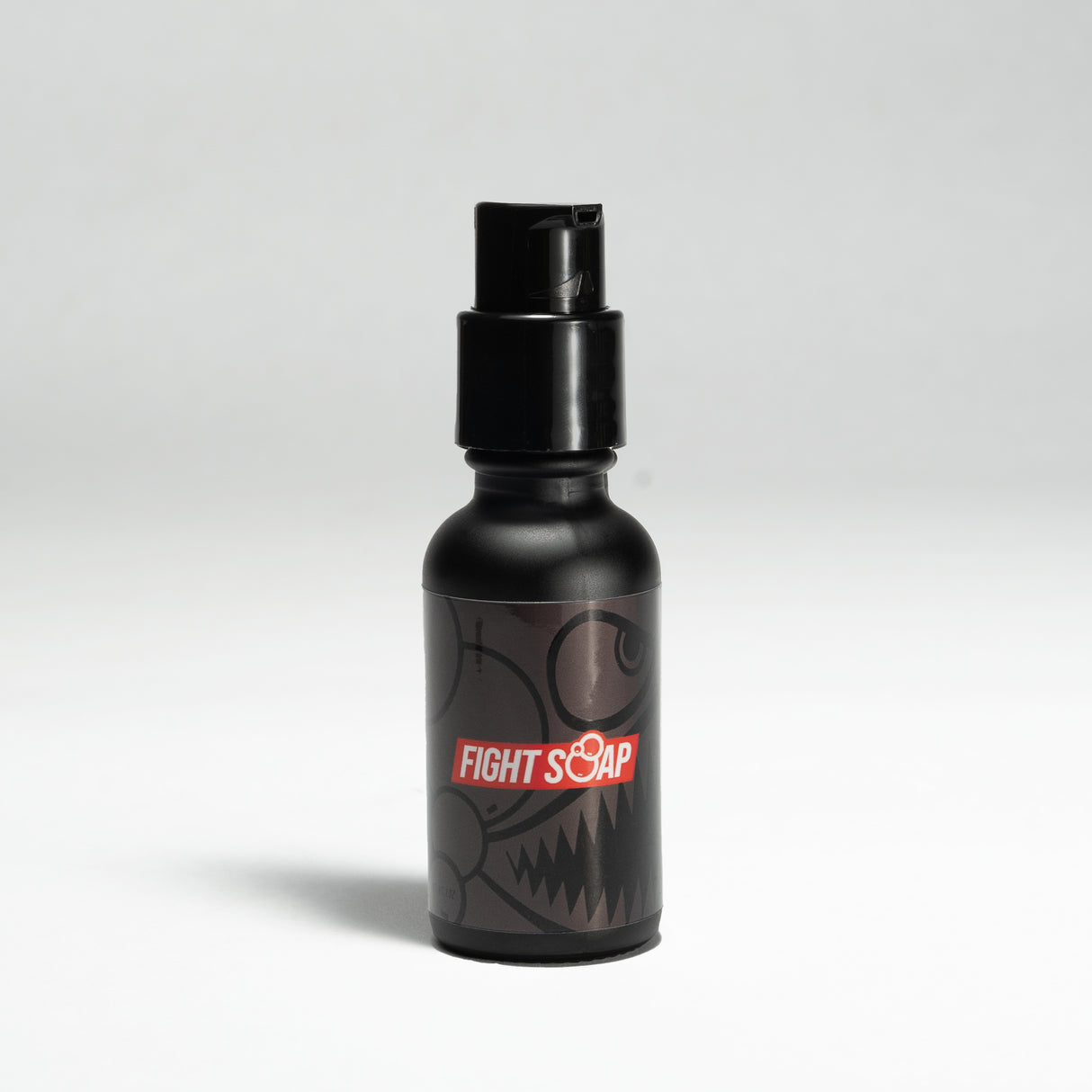 Black spray bottle labeled "Fight Soap" with a fierce, cartoonish monster face design, used for beard grooming or styling.